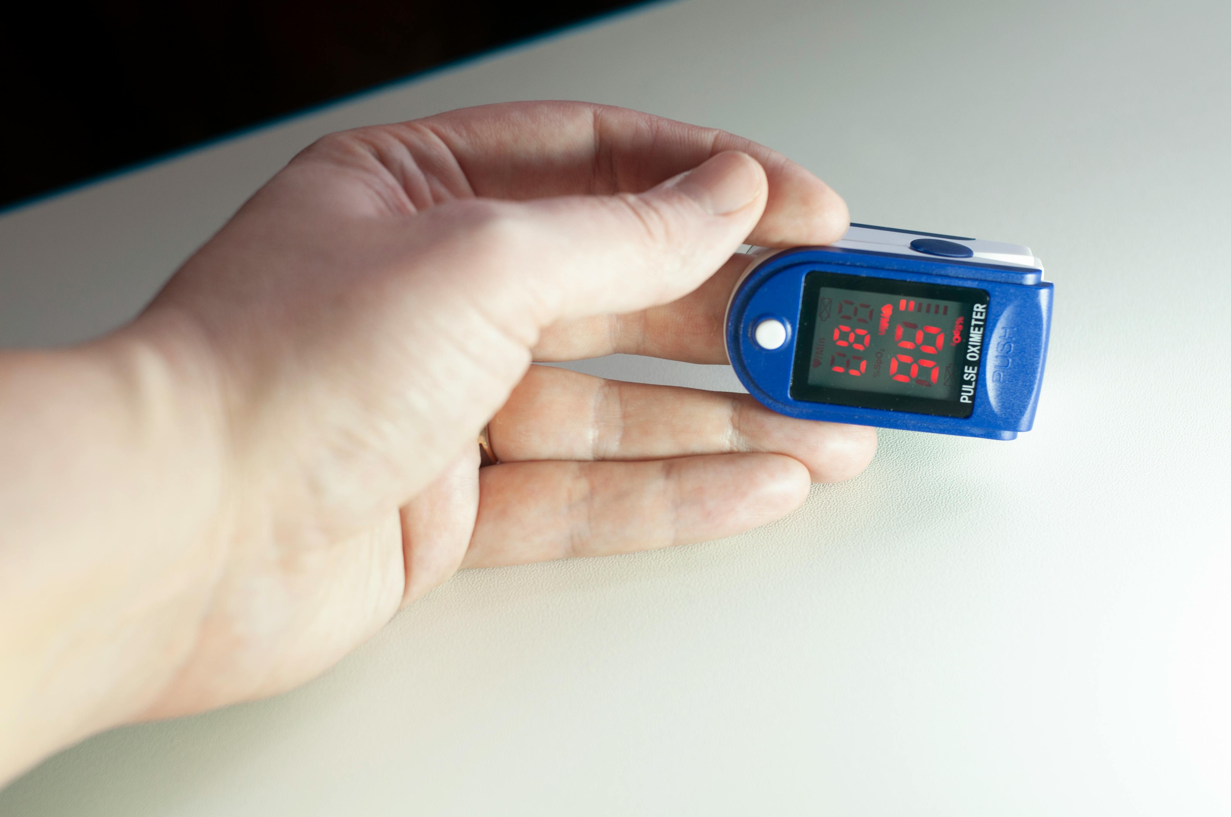 Finger pulse oximeter on a hand